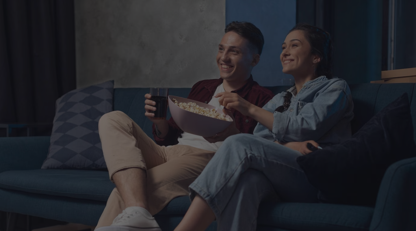 Apollo Group TV — a couple streaming their favorite HD content on the couch, anytime, anywhere, any screen